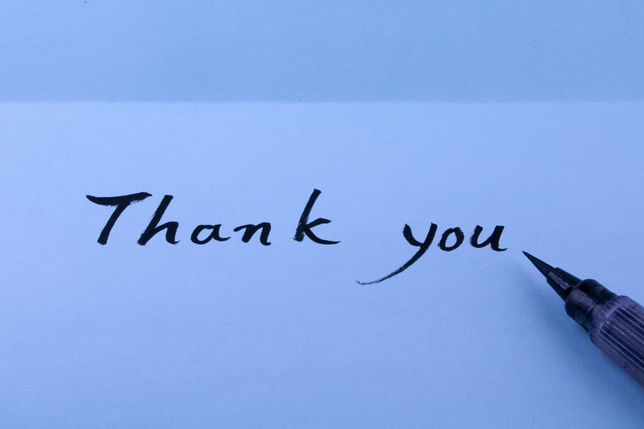 Letter pen writing thank you message hand print