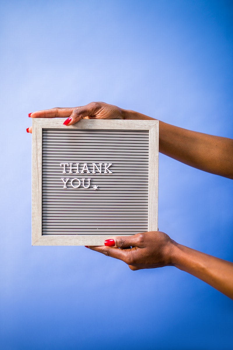 Person Holding Gray and White Box with Thank You text